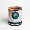 A can of 'Botanical - Soft Coral Pink Blushing Coral Clay and Chalk Paint' by Daydream Apothecary with a paintbrush dipped into the paint.