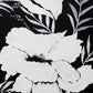 Tissue paper with a black and white tropical floral print design, with visible white and black paint strokes.
